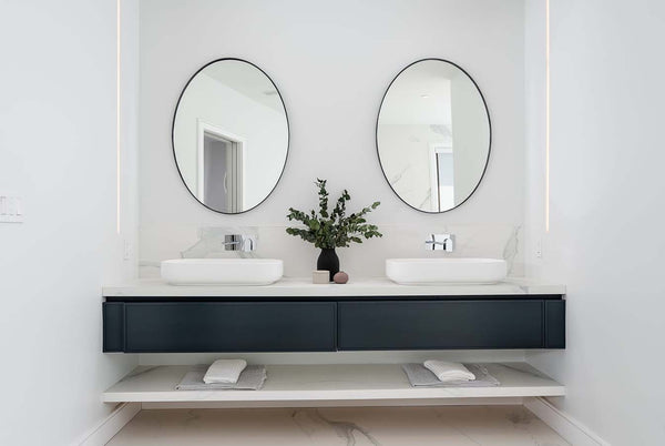 floating vanity with double black oval mirrors